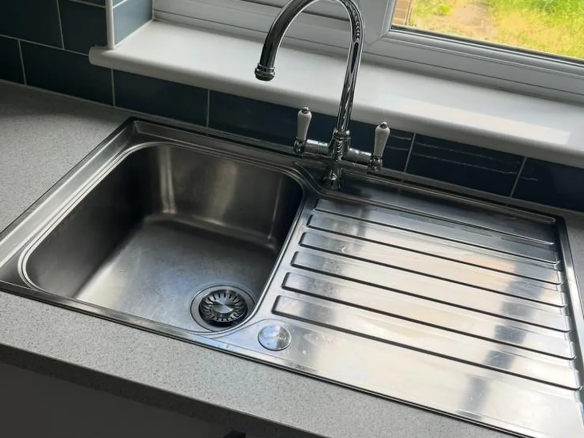 Kitchen sink cleaned to a shine after a deep clean