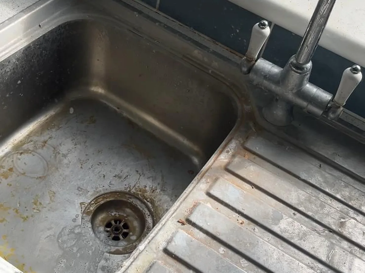 Grimy kitchen sink before a deep clean